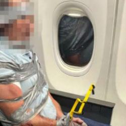 U&ccedil;akta taşkınlık yapan yolcuyu koli bandıyla bağladılar