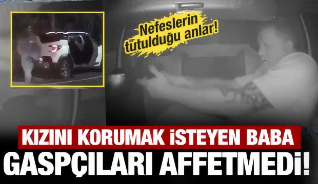 Gasp&ccedil;ılarla &ccedil;atışan babanın kızını koruduğu anlar viral oldu